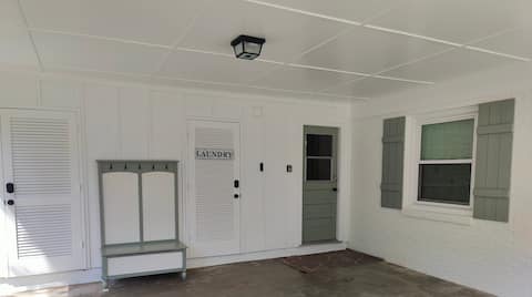 Carport, main house entry is the green, mudroom door to the right, next to the laundry room door.